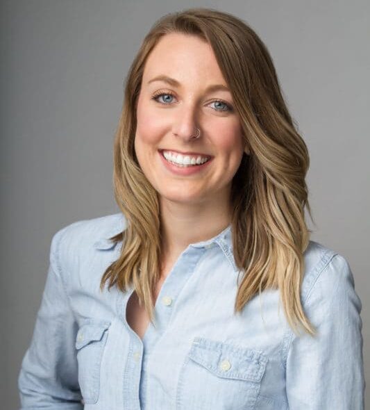 Real estate agent in a light chambray shirt smiling for a professional headshot