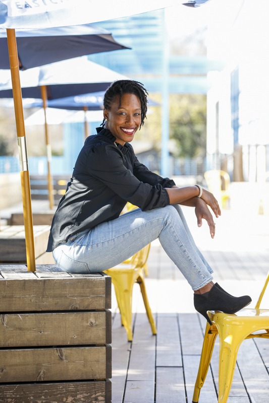 black woman in jeans and blazer outside personal branding