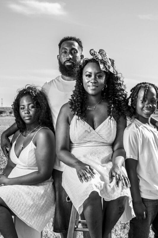 black family in blue bonnet field