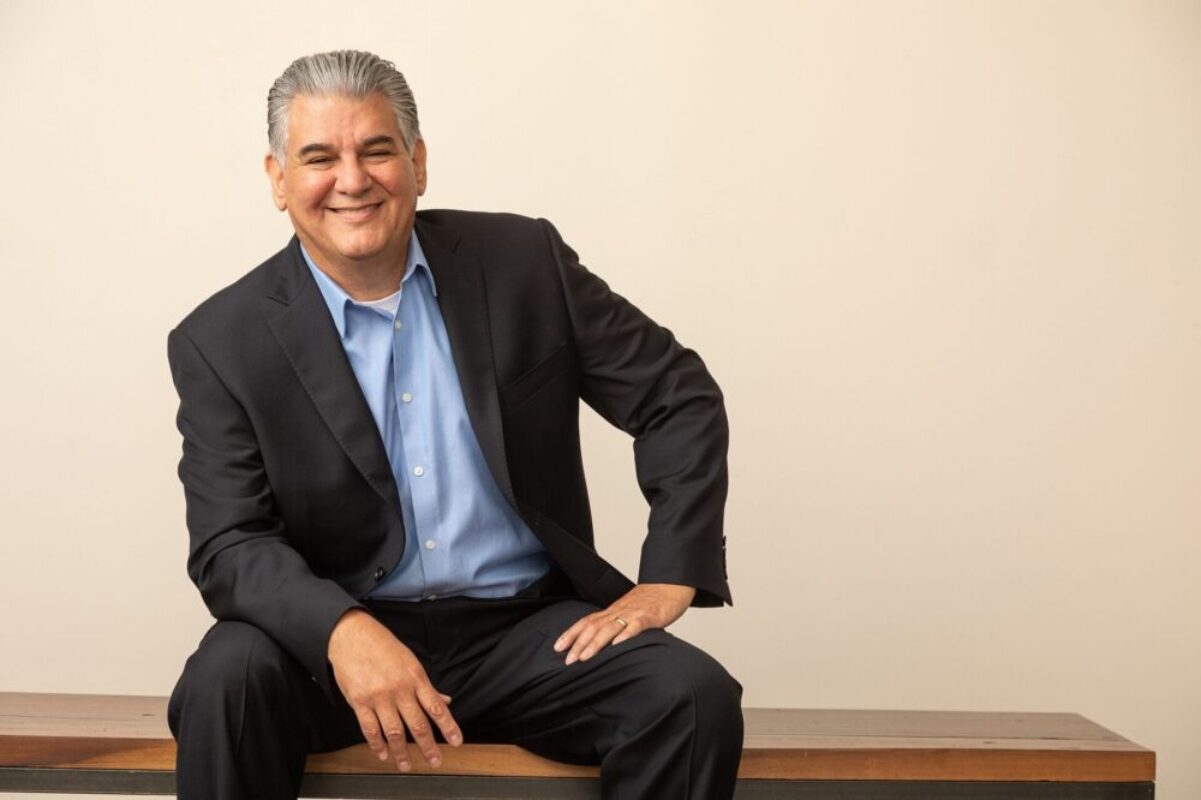 mexican man on bench in suit 