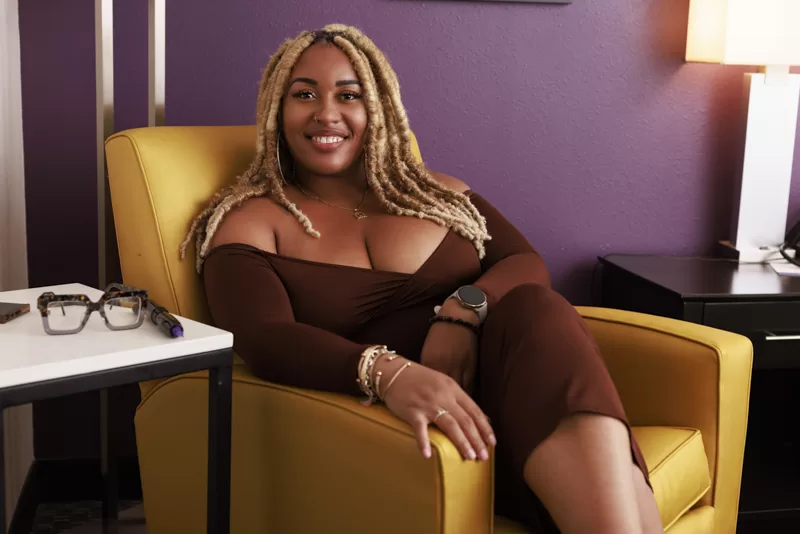 Austin black business woman portrait in yellow chair