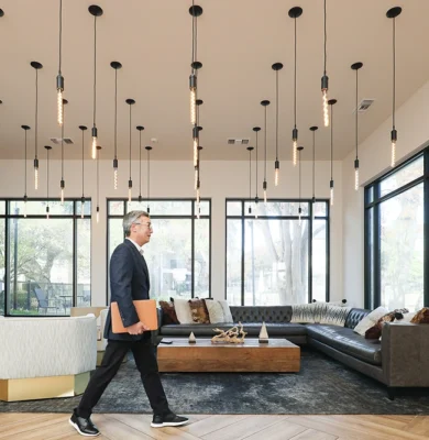 CEO walking though fancy lobby with laptop on the way to a meeting