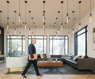 CEO walking though fancy lobby with laptop on the way to a meeting