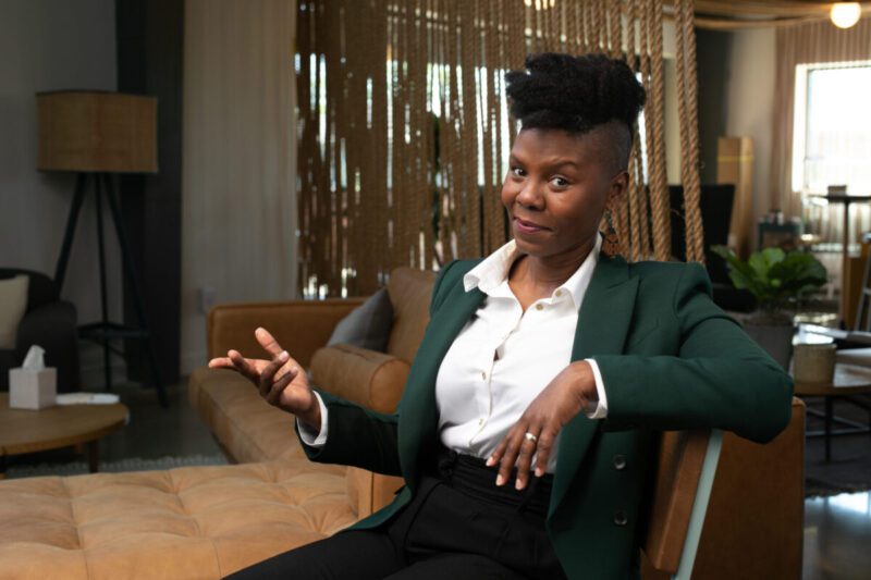 black woman with mohawk in green jacket