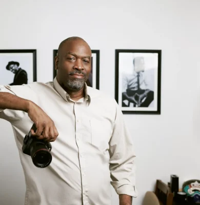 Eric Coleman, Austin brand photographer, holding a camera in his studio