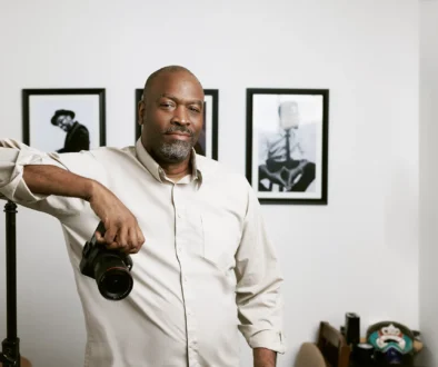 Eric Coleman, Austin brand photographer, holding a camera in his studio