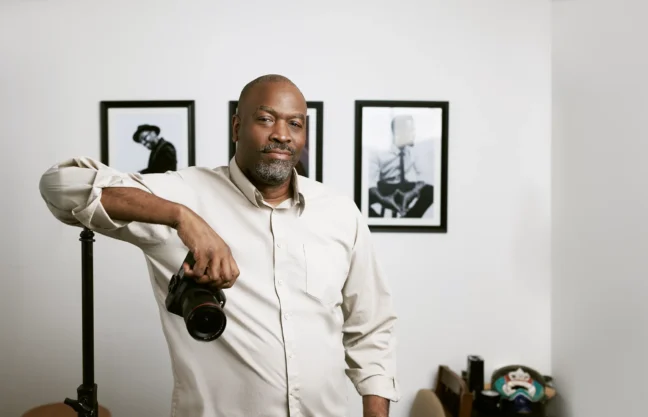 Eric Coleman, Austin brand photographer, holding a camera in his studio