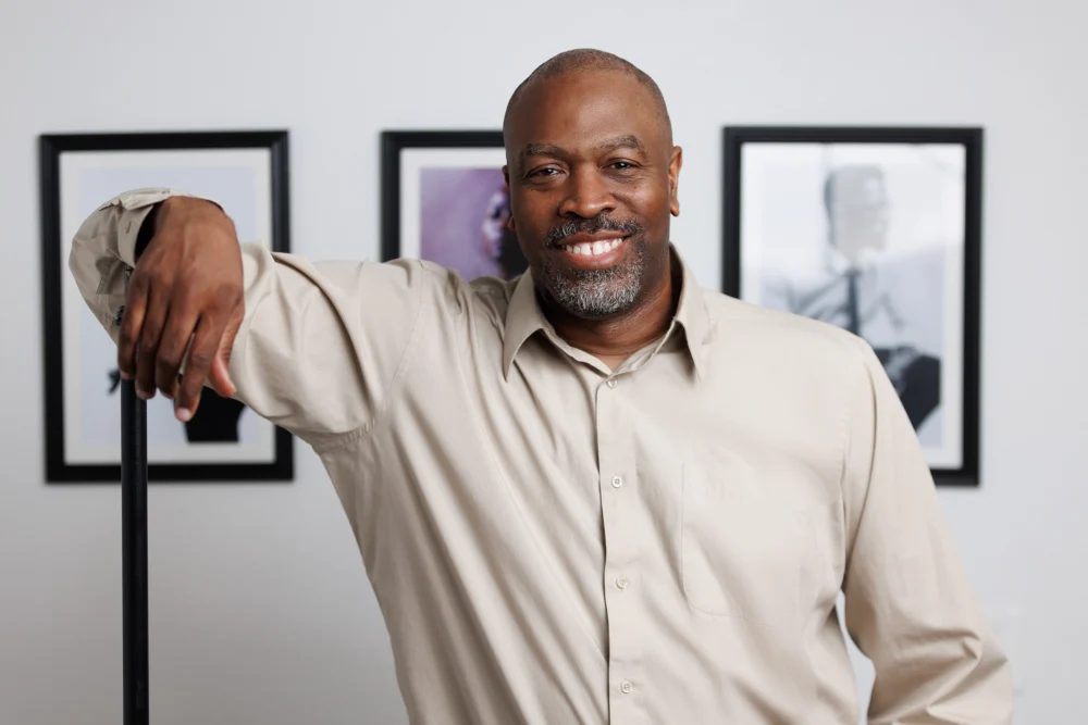 Austin Brand Photography photographer eric coleman with brown shirt in studio smiling at the camera