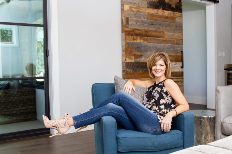 Austin professional organizer photographed in a blue chair for her brand session