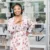 Austin Brand photography of lady in flower dress in front of window